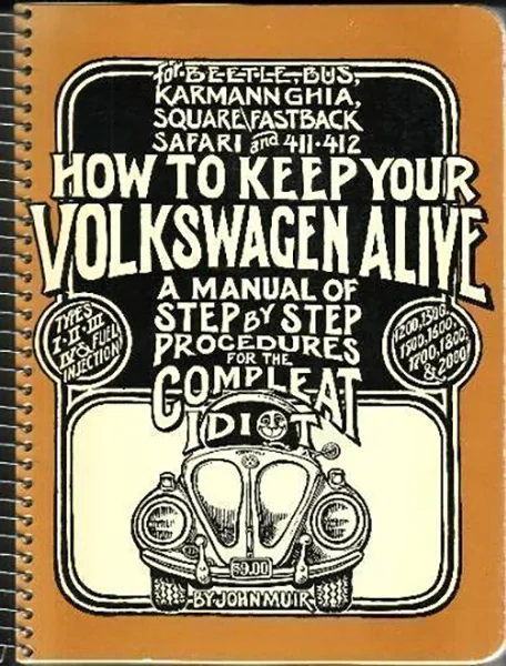 Vintage orange-bound Volkswagen repair manual cover with front Beetle illustration